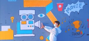 boy in white long sleeve shirt and blue pants standing in front of wall with painting